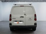 the back end of a white van parked in a garage
