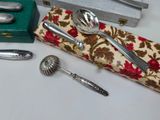 silverware and spoons sitting on a table next to a box