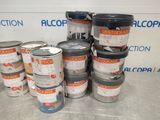 several buckets of paint are stacked on a table in front of a sign