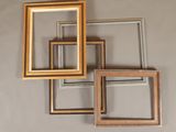 four different colored frames hanging on a wall in a room