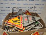 a cardboard box filled with assorted construction signs