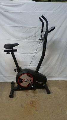 a black and red exercise bike with a black seat