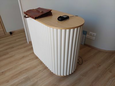 a white radiator sitting on top of a wooden table
