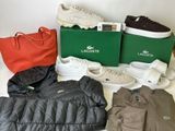 several pairs of lacoste shoes, a jacket, a bag, and a pair of tennis shoes