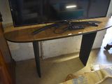 a flat screen tv sitting on top of a wooden table