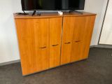 a television on a cabinet in the corner of a room