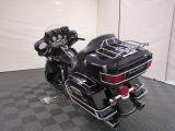 a black motorcycle that is parked on a checkered floor