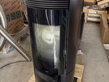 a black stove sitting on a pallet in a warehouse