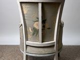 a chair with a floral design on it in a room