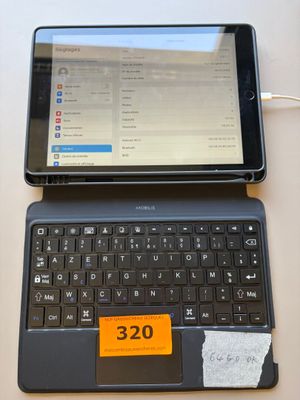 a tablet computer sitting next to a laptop computer on a table