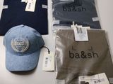 a hat, t - shirt, and other items on a table