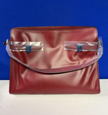 an image of a red purse with clear handles on a table