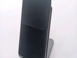 a cell phone that is sitting on top of a stand