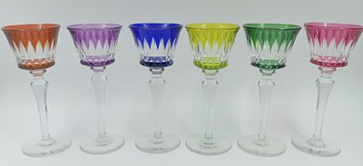 plusieurs verres à vin de couleurs différentes sont alignés