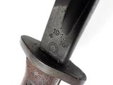 a close up of a knife with a top hat on it