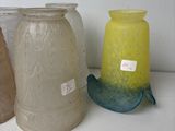 several vases are lined up on a shelf with labels on them