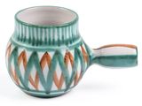 a cup with a handle on a white surface