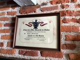 a plaque on a brick wall with a picture of a crown on it