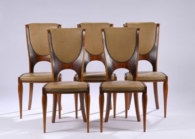 four wooden chairs with leather upholstered seats on a white background