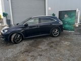 a picture of a black car parked in front of a building