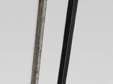two black and gold chopsticks sitting next to each other on a white surface