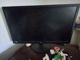 a computer monitor sitting on top of a wooden desk