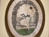 a picture of a woman in a white dress hanging on a wall
