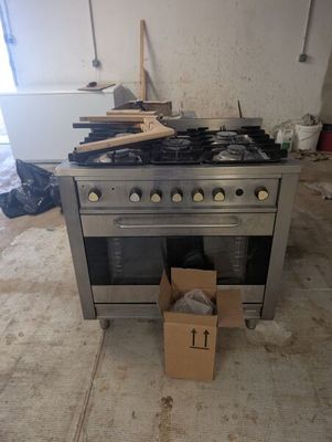 a stove with a box on the floor next to it