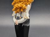 a figurine of a woman with a red hair