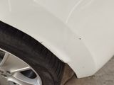 a close up of a car ' s front bumper and tire