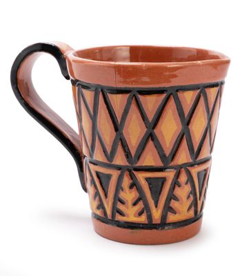 a brown and black cup with a design on it