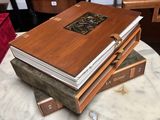 several books stacked on top of each other on a marble table