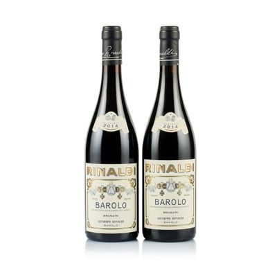 two bottles of wine sitting next to each other on a white surface