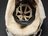 a helmet that is sitting on top of a cloth bag