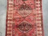 a red rug with a diamond design on it
