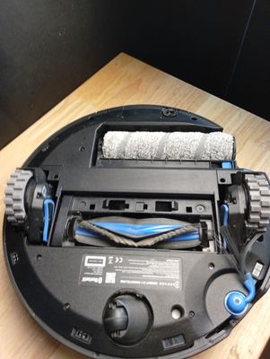 a robot that is sitting on a table with a towel