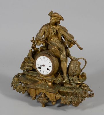 a bronze clock with a man and a dog on it