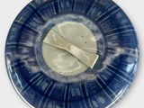 a blue plate with a piece of cheese on it