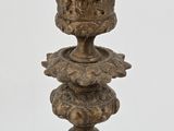 a blue glass vase with a gold decoration on top of it