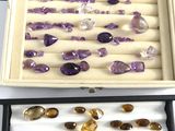 a box with a bunch of different colored stones in it