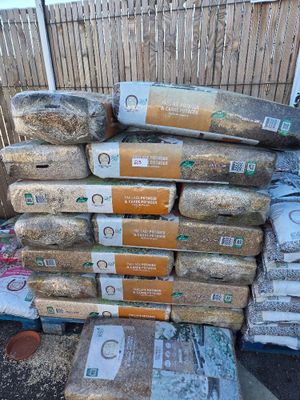 a pile of bread sitting on top of a pile of bags