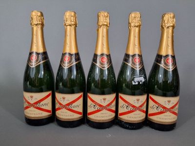 six bottles of champagne are lined up in a row