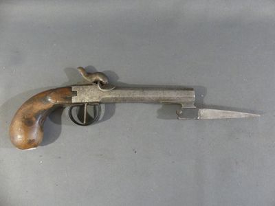 a small gun with a wooden handle on a table