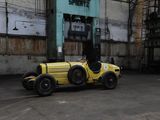 a yellow car that is parked in a parking lot