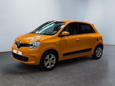 the orange car is parked in the room of the building