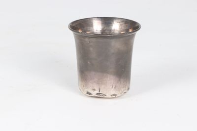 silver plated shot glass with a silver rim on a white background
