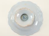 a white plate with a blue and white flower on it