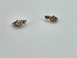 a pair of silver earrings on a white surface