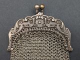 an antique silver metal mesh purse with a metal clasp