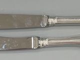 two knives that are sitting next to each other on a table